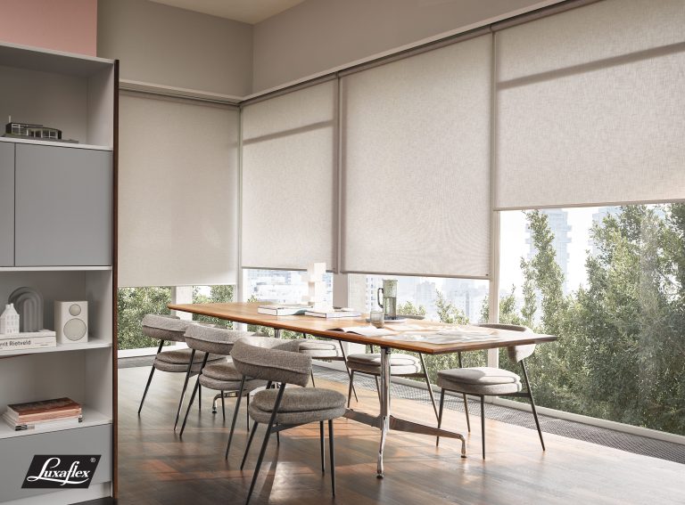 Modern dining room with Luxaflex roller blinds, wooden table, gray upholstered chairs, and city skyline view.