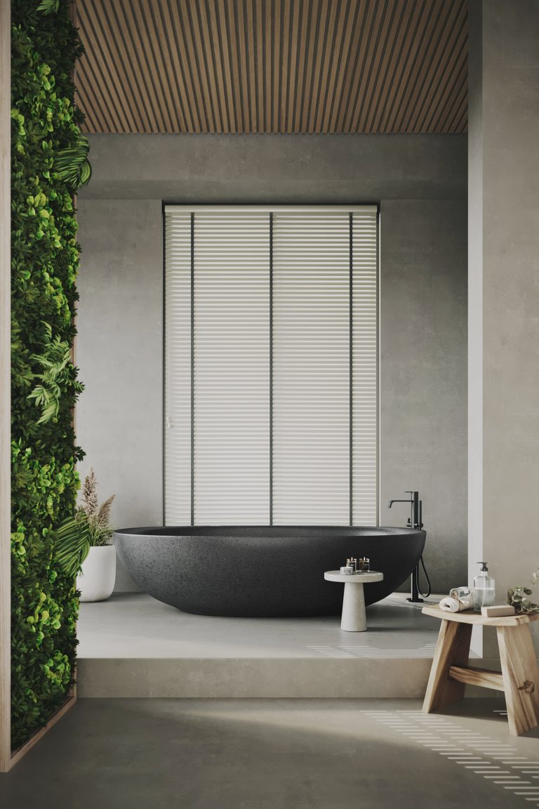 Modern spa bathroom with black stone freestanding tub, wood slat ceiling, concrete walls, and living green plant wall.